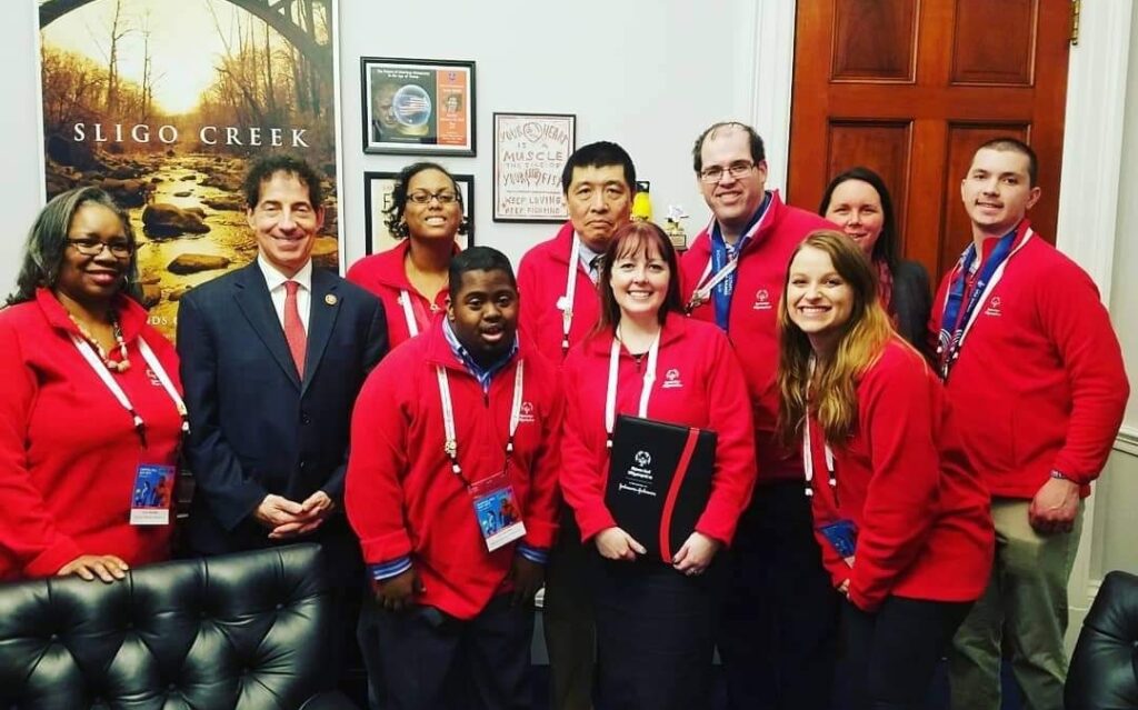 Laura pictured center in red with the Special Olympics Team